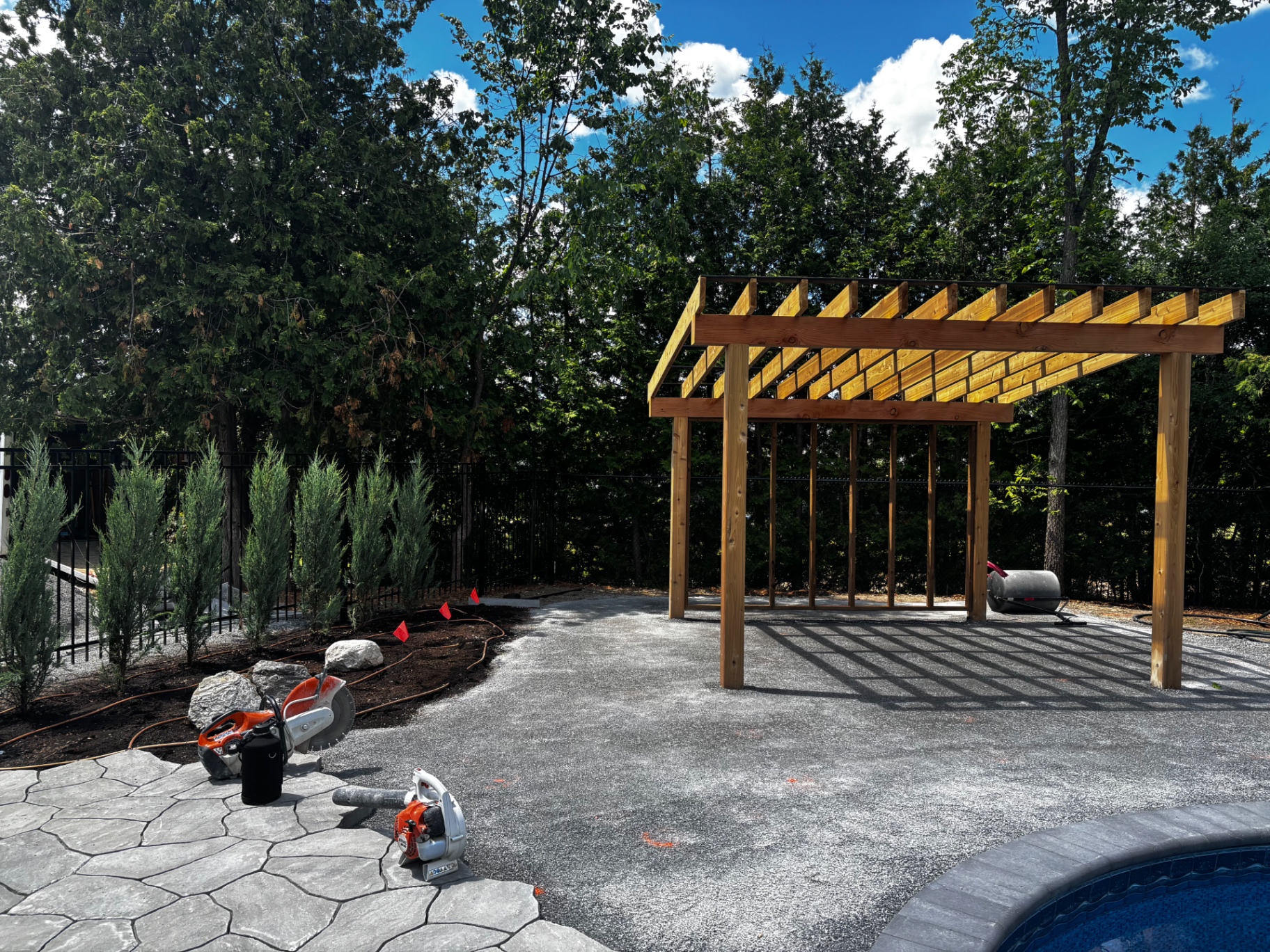 Cedar pergola framing under construction poolside